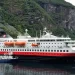 Hurtigruten ship sailing Norwegian fjord